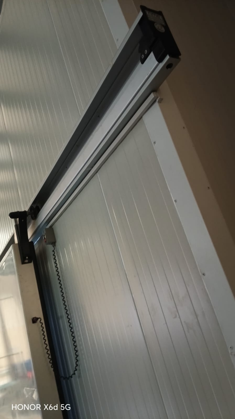 Air curtain unit installed above a cold store sliding door