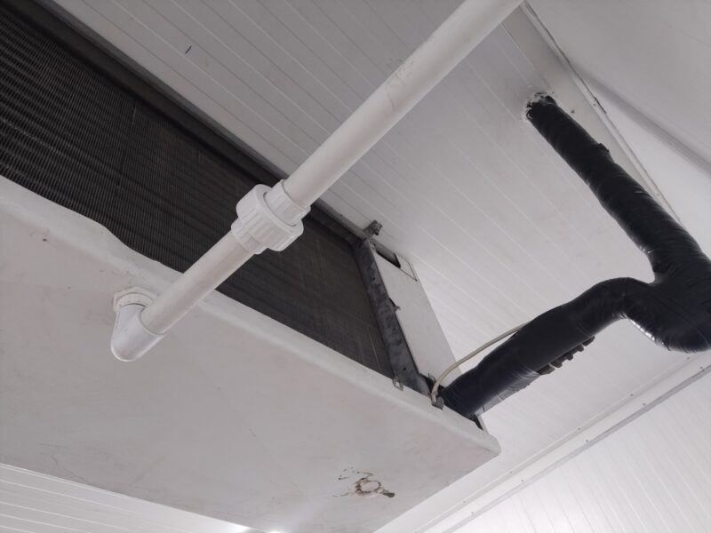 Cold room ceiling showing evaporator drainage pipework and insulated refrigerant lines