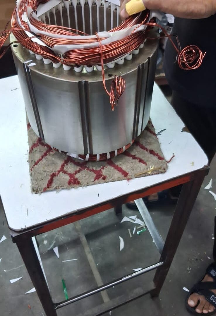 Compressor motor stator being rewound with new copper windings in the Chillex workshop