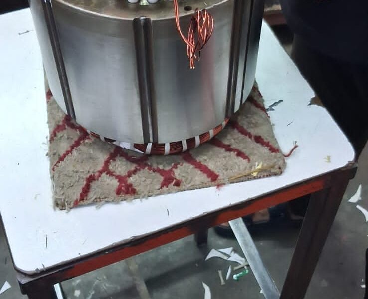 Compressor motor stator being rewound with new copper windings in the Chillex workshop