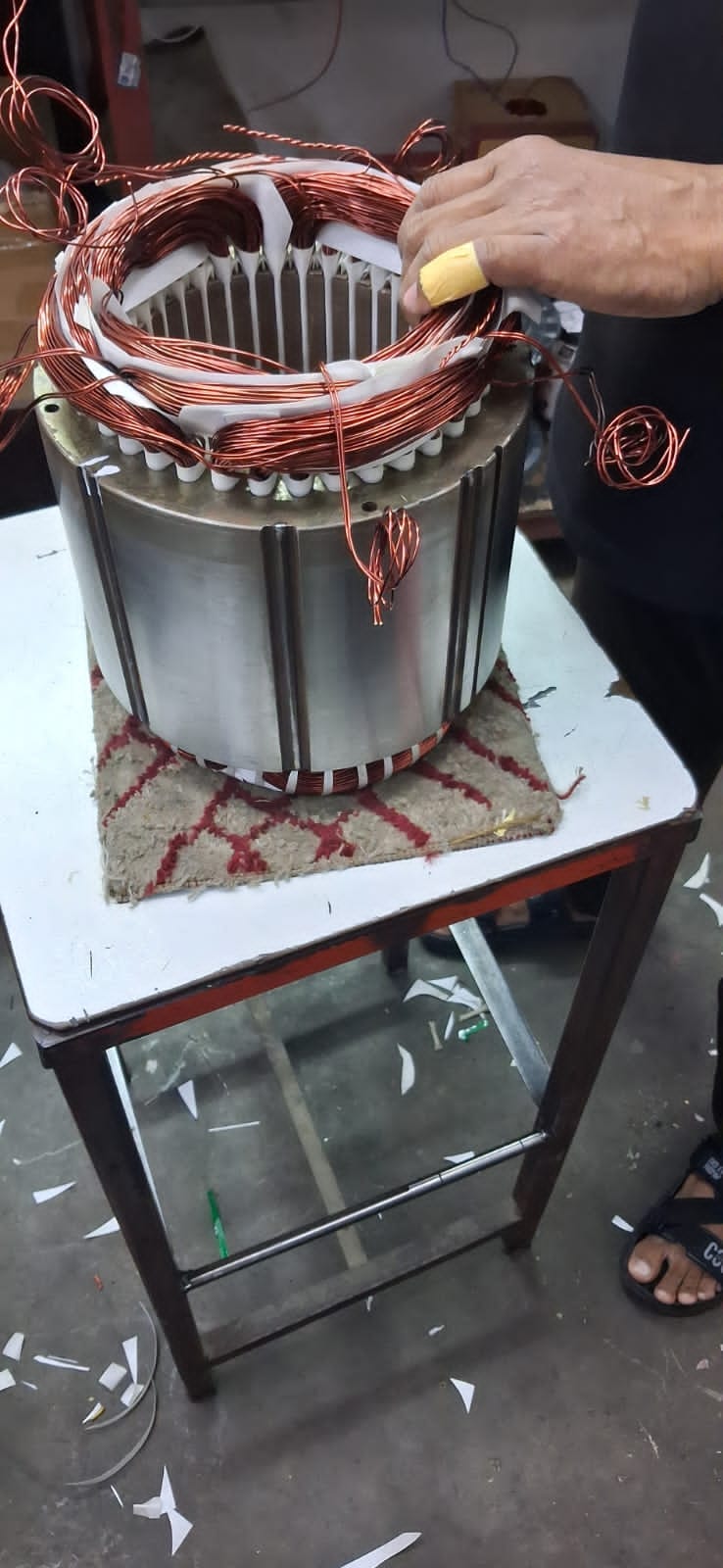 Compressor motor stator being rewound with new copper windings in the Chillex workshop