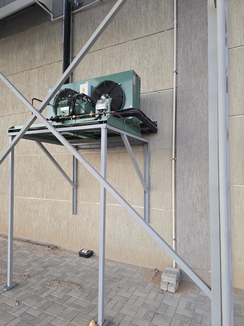 Refrigeration pipework and insulated headers running from condensing units at a UAE cold store