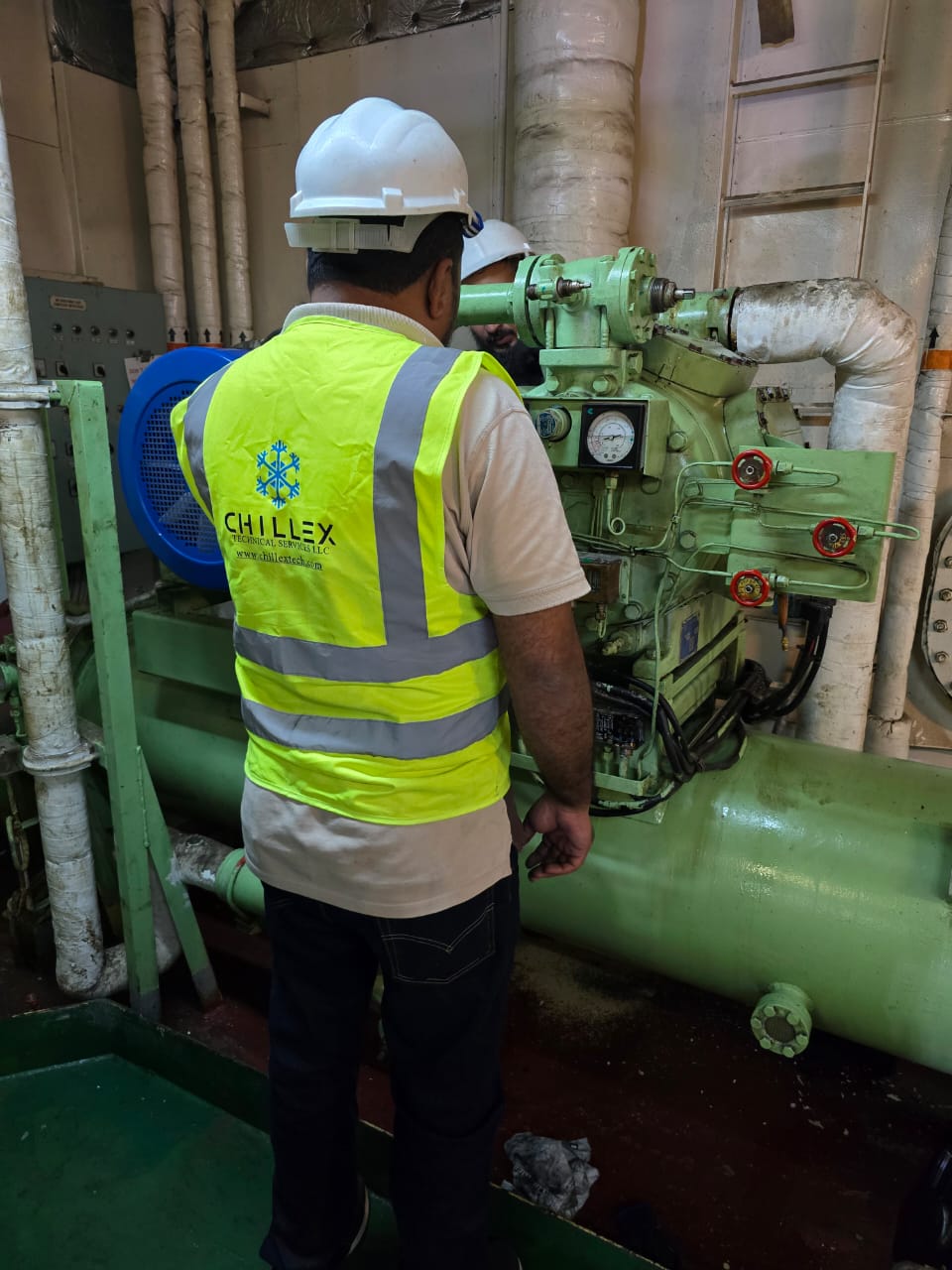 Two Chillex engineers carrying out preventive maintenance on a vessel's refrigeration plant