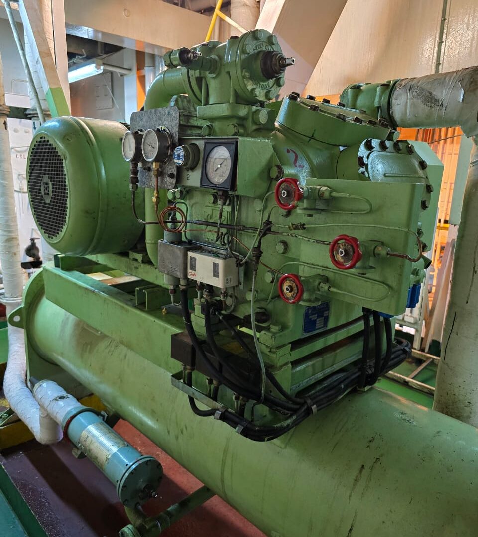 Marine reciprocating refrigeration compressor and receiver assembly in a vessel engine room
