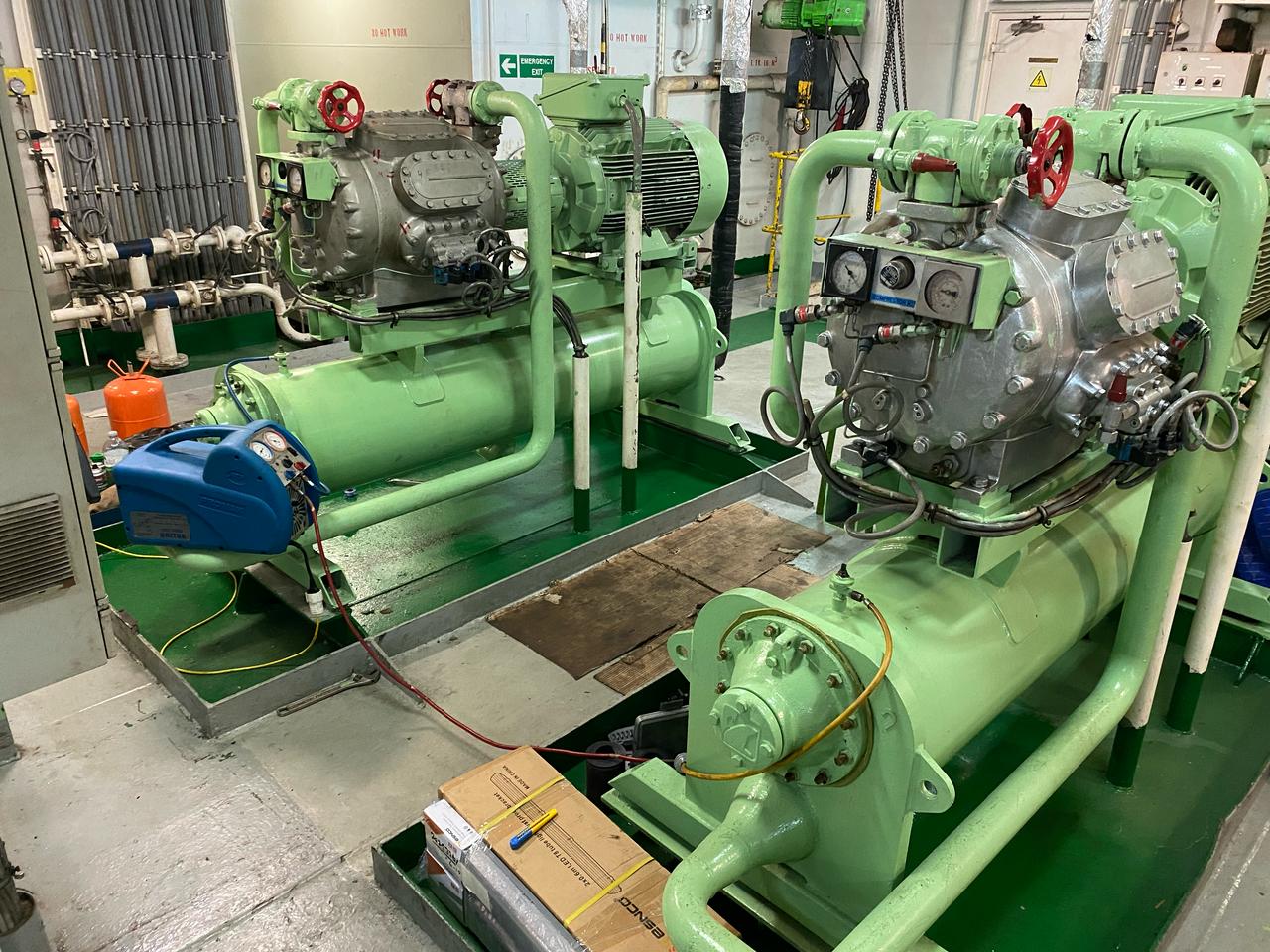 Refrigerant recovery unit connected to a marine refrigeration compressor during planned preventive maintenance